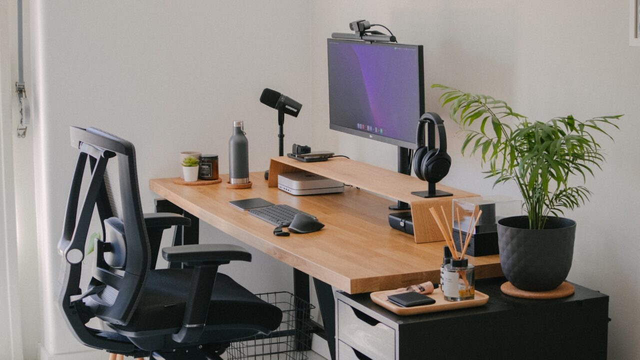 Clean work from home desk setup with monitor and plants