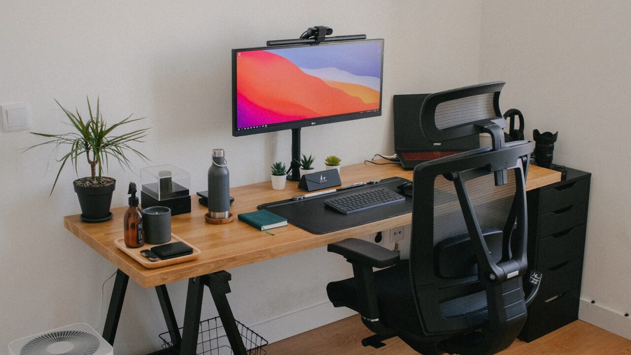 Ergonomic desk setup with chair monitor and keyboard