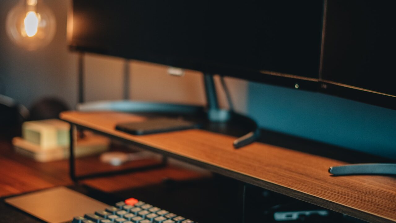 Top down keyboard and mouse on a desk surface