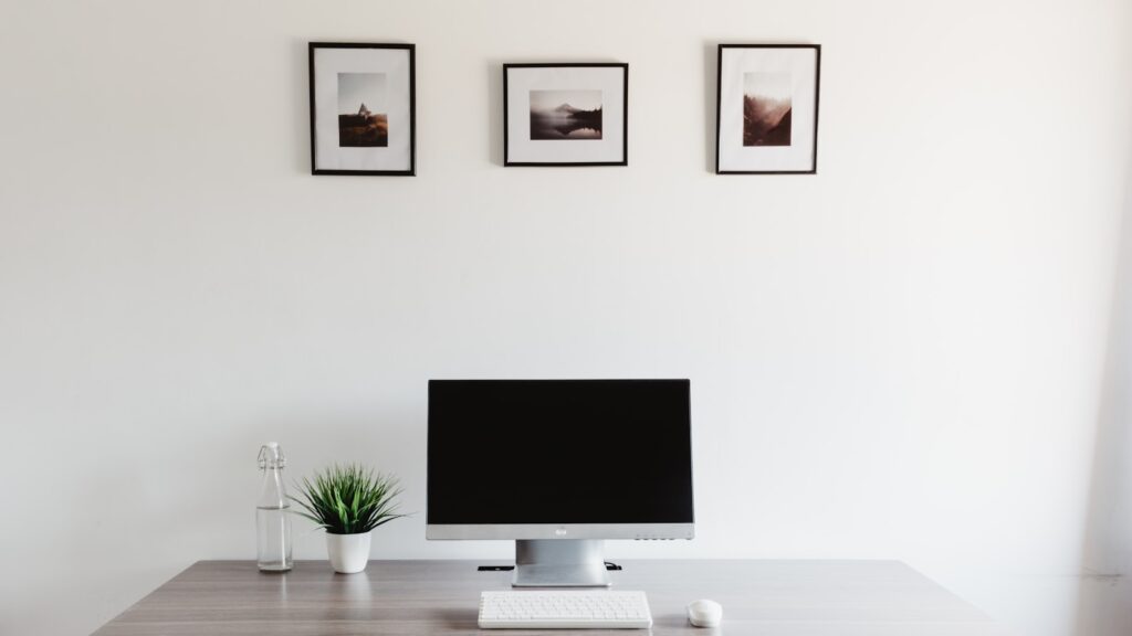 Minimal desk setup with monitor keyboard and clean surface