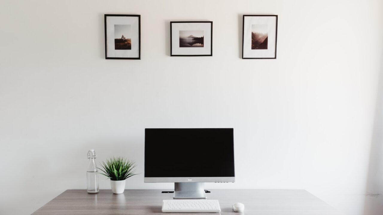 Minimal desk setup with monitor keyboard and clean surface
